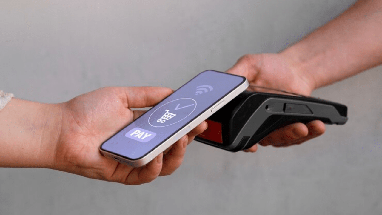 Customer paying with his smartphone through smart payment gateway