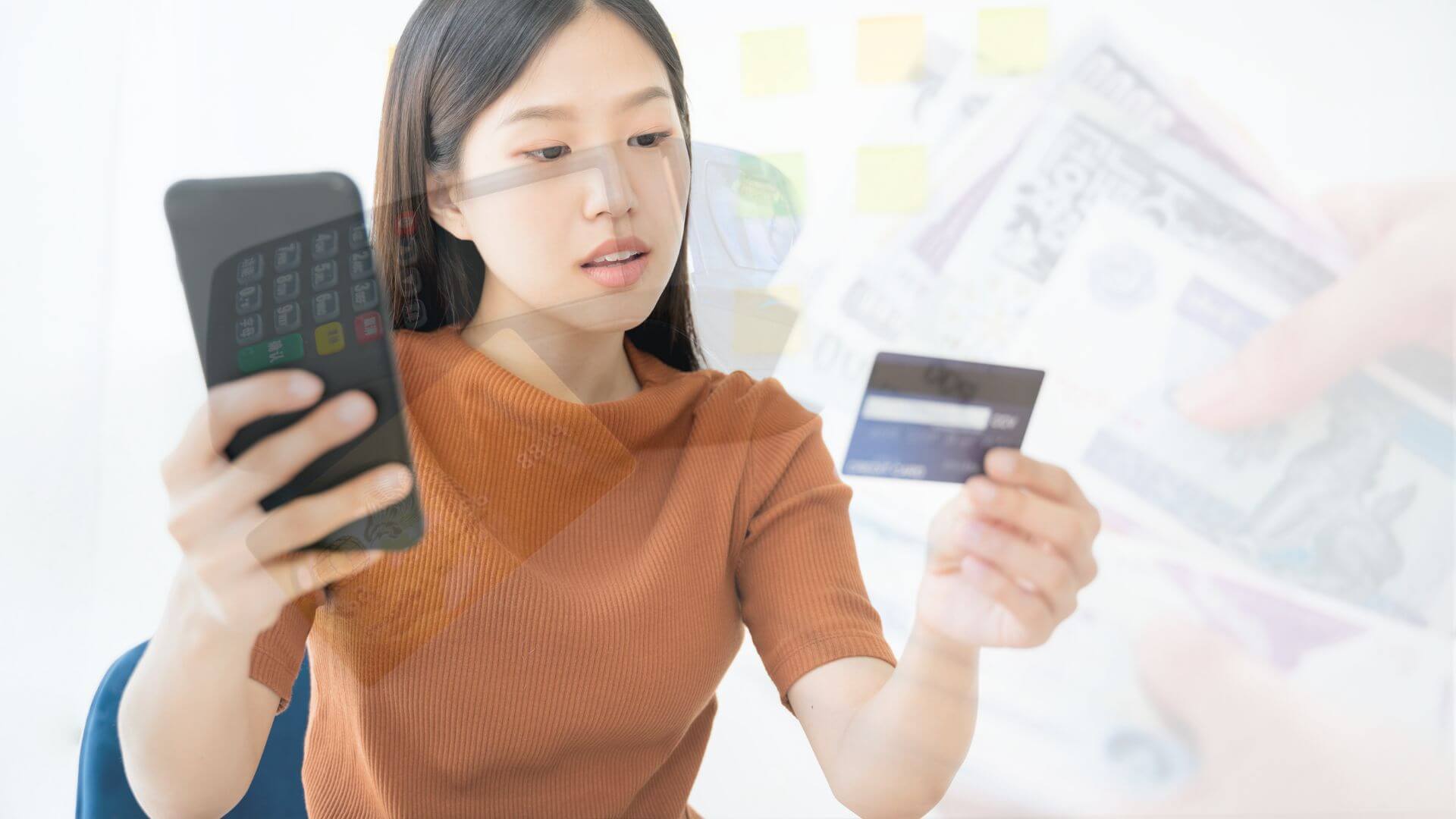 young-woman-in=yellow-brown-shirt-using-phone-while-doing-online-shopping-holding-card-and-blurred-background-of-money-and-terminal-machine