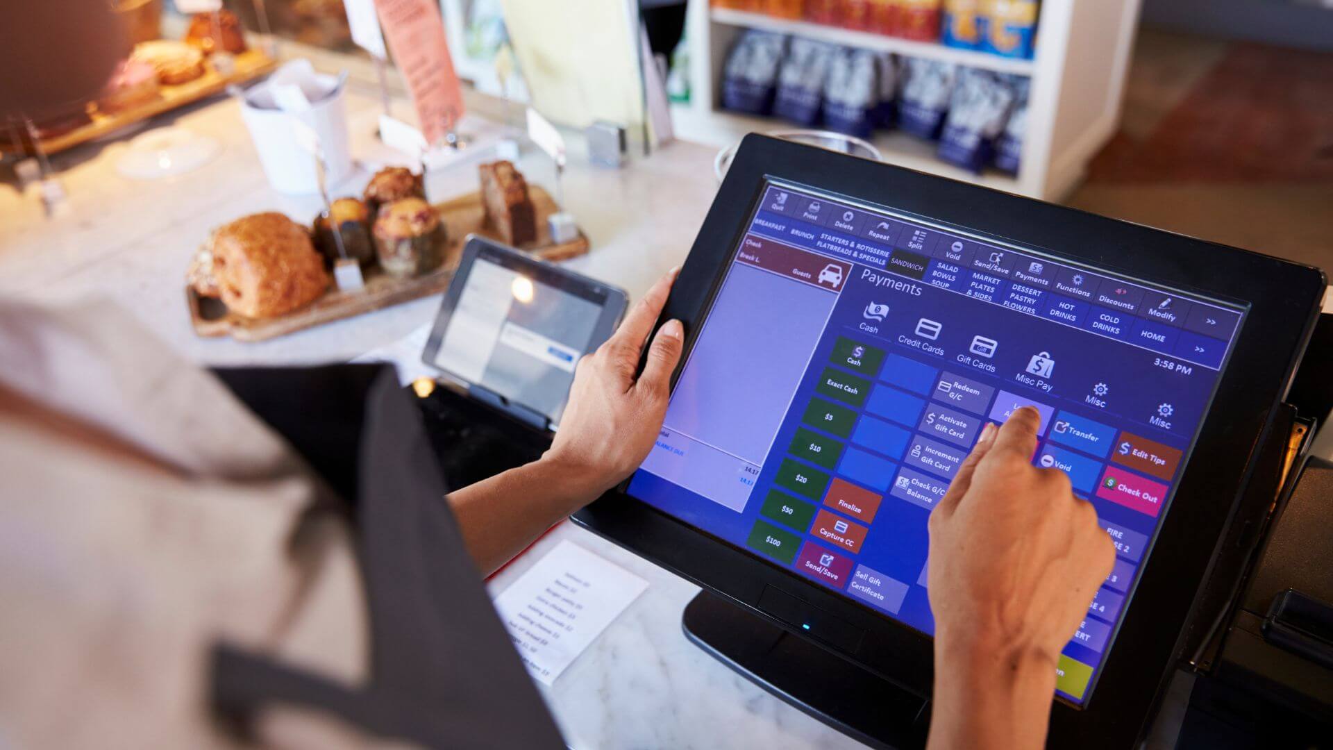 close-up-of-female-employee-staff-working-at-cashier-checkout-using-pos-machine