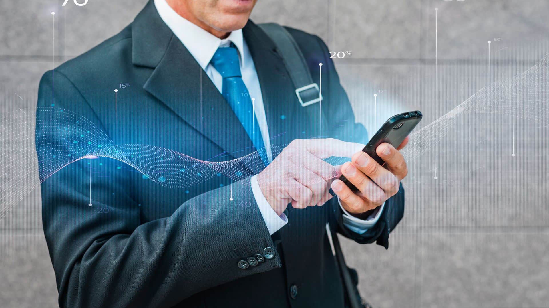 A business man in suit holding phone checking statistic