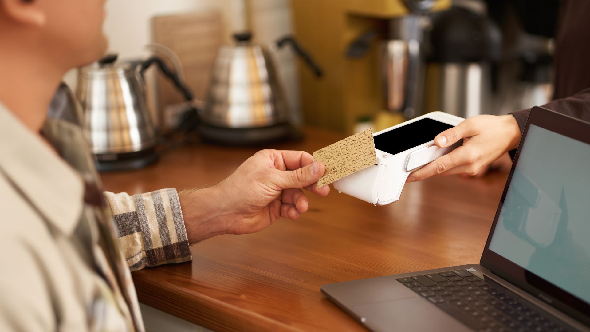 A man using his card to tap and wave pay on the Paydibs payment terminal machine