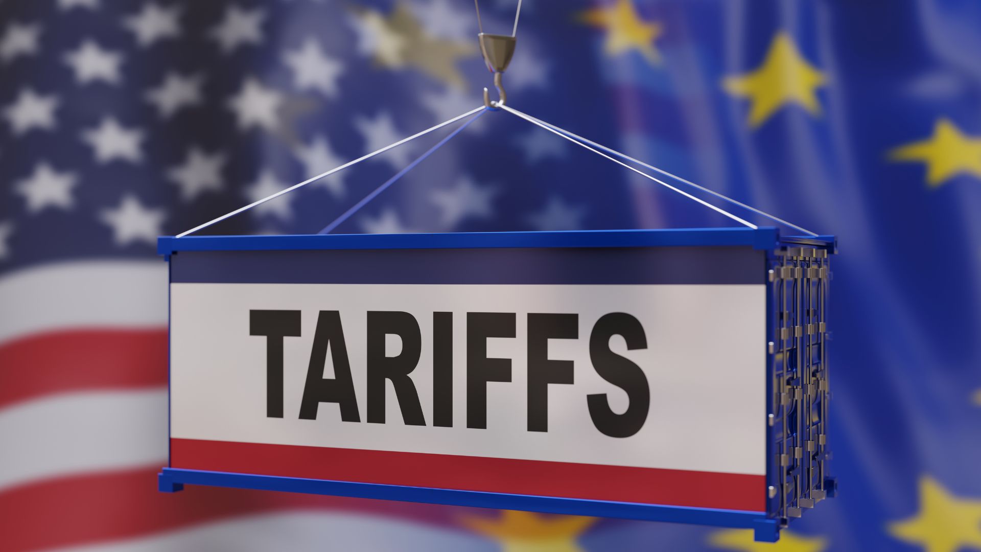 A Tariff wording printed on a cargo box hang in the air with US flag in background