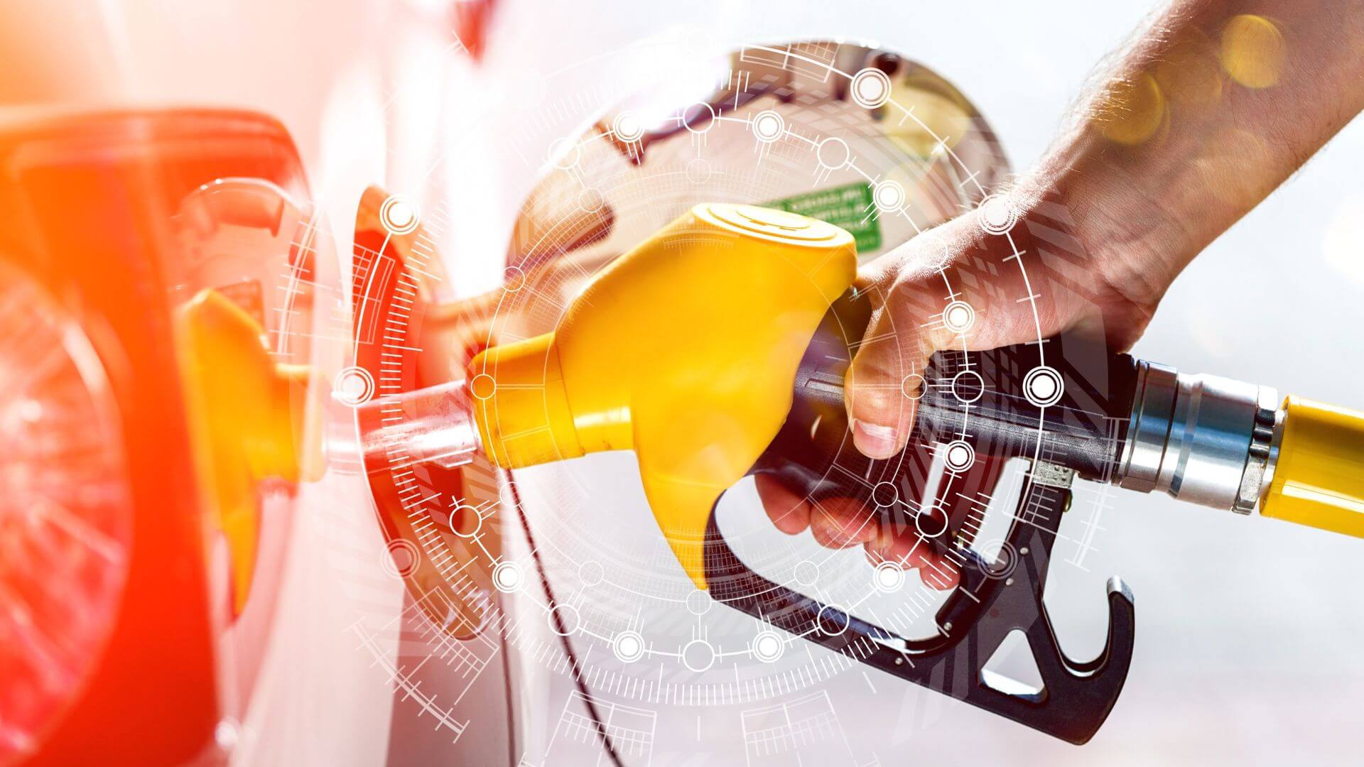 Hand refueling car with yellow fuel nozzle, symbolizing Malaysia’s RON95 price cut and energy economy insights.