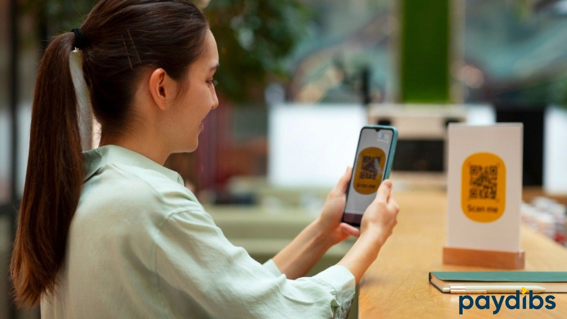 A girl scanning QR code to make payment