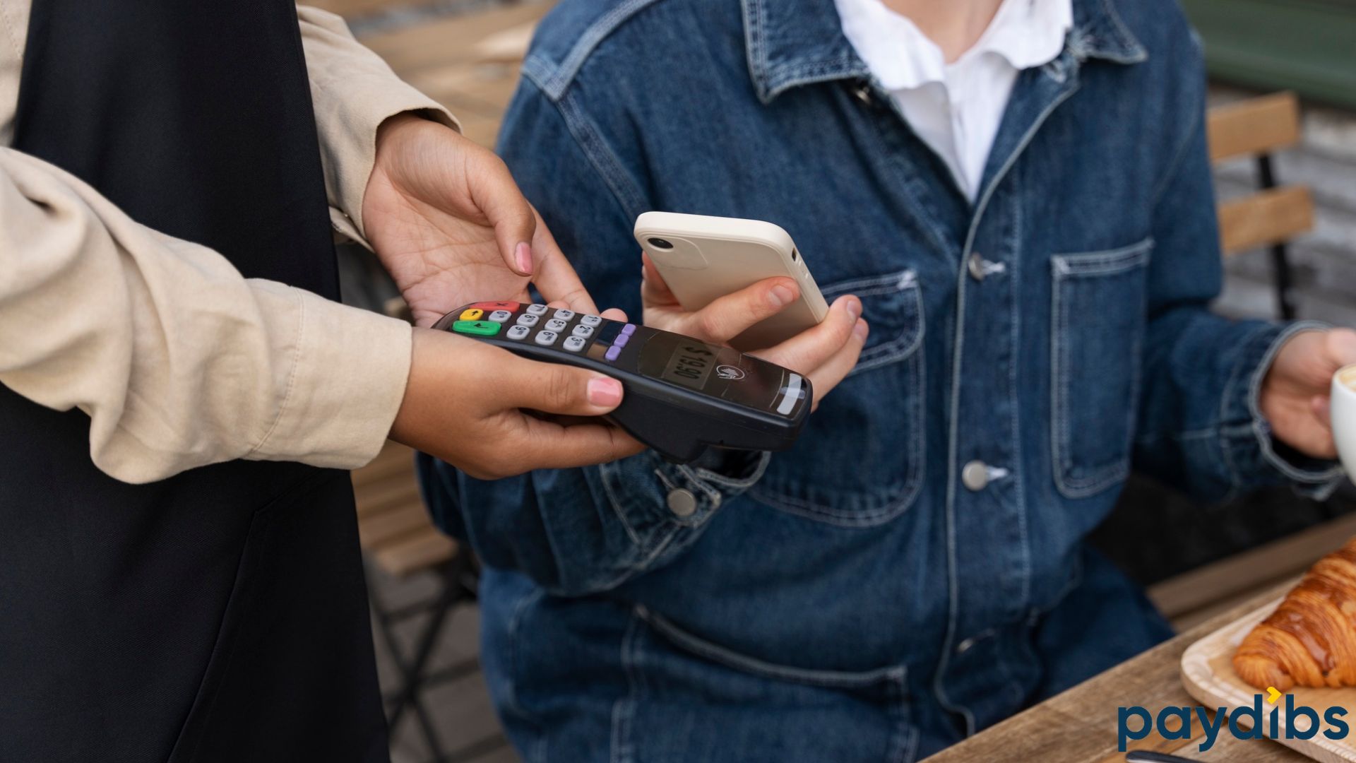 A man trying to scan the QR on payment machine in a restaurant