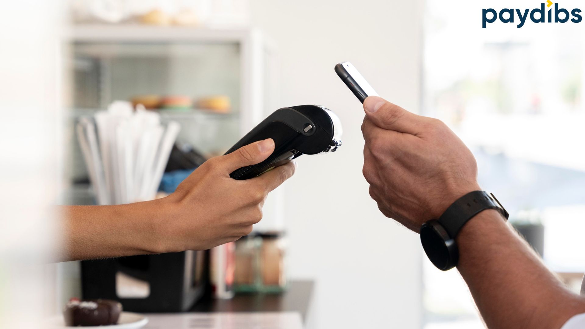 A man using mobile pay to a pos terminal