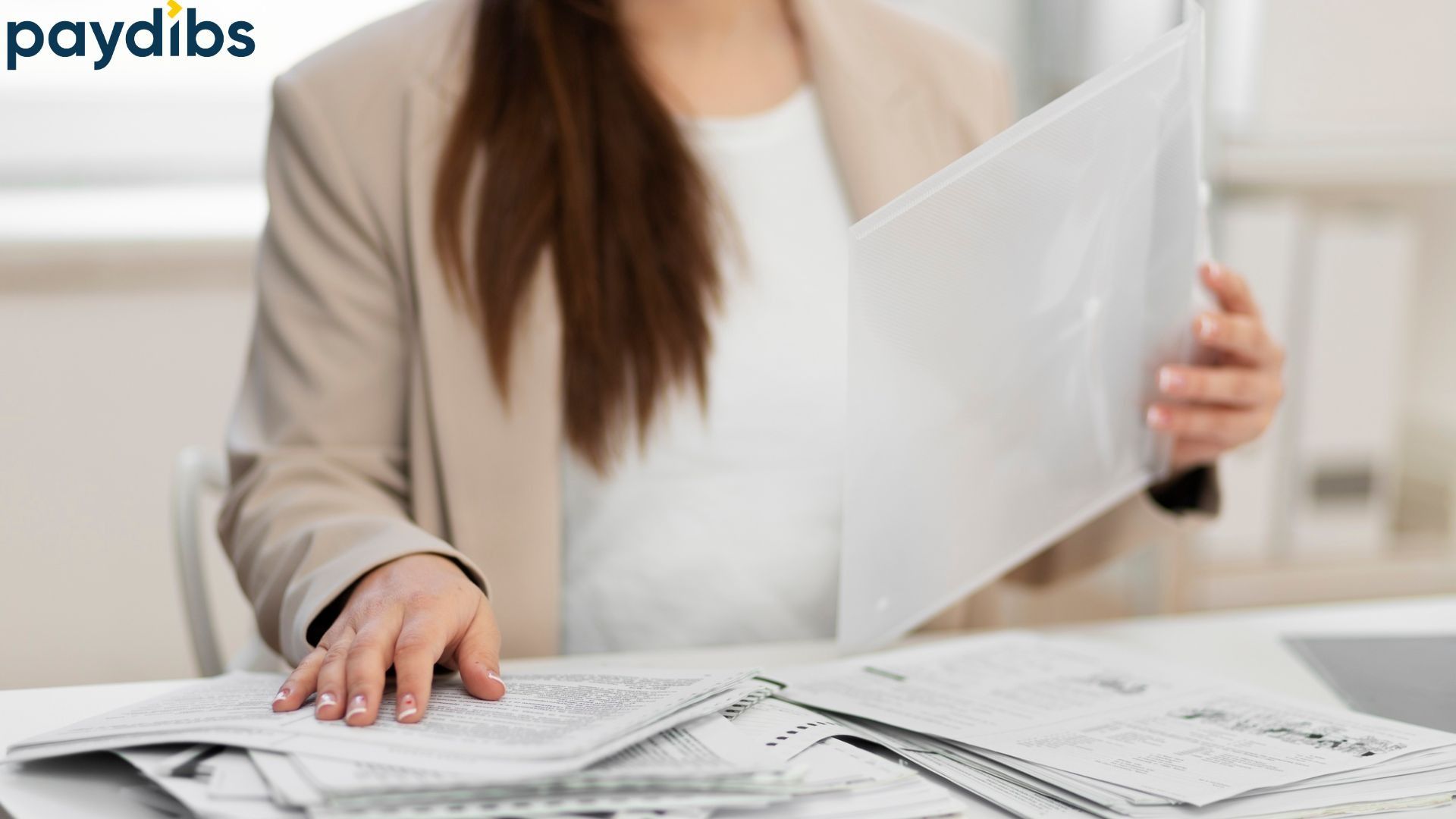 A woman checking documents to verify the tin mismatch.